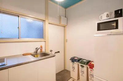 a small kitchen with a sink and a microwave at Central Panda Hotel in Tokyo