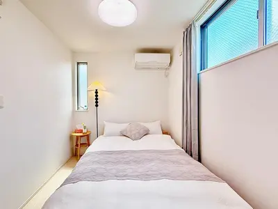 a small bedroom with a bed and a window at Yodamari House Ikebukuro Direct access to Shinjuku and Shibuya7 people OK! in Tokyo