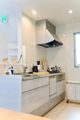 a kitchen with white cabinets and a sink at Yodamari House Ikebukuro Direct access to Shinjuku and Shibuya7 people OK! in Tokyo