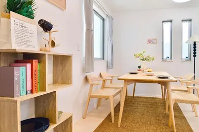 a room with a table and chairs and a book shelf at Yodamari House Ikebukuro Direct access to Shinjuku and Shibuya7 people OK! in Tokyo