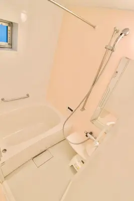 a white bathroom with a shower and a toilet at Yodamari House Ikebukuro Direct access to Shinjuku and Shibuya7 people OK! in Tokyo
