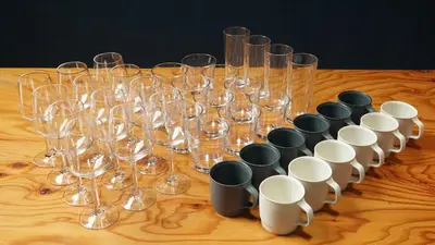 a bunch of wine glasses sitting on a wooden table at SUNPIKA Tokyo in Tokyo