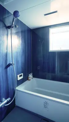 a blue bathroom with a tub and a shower at SUNPIKA Tokyo in Tokyo