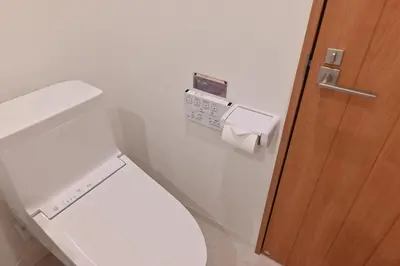 a white toilet in a bathroom with a wooden door at Skytree Luxury Villa - 2025 New, to Skytree, Direct Airport Access in Tokyo