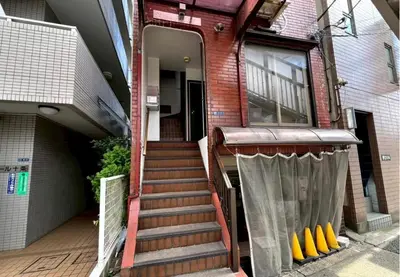 a stairway leading to a house with a door at I HOUSE jujo in Tokyo