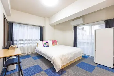 a bedroom with a bed and a desk and a window at ksi\u5357\u5e38\u76e4\u53f0302 in Tokyo