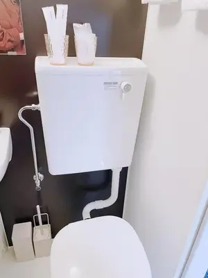 a white toilet with two cups on top of it at ksi\u5357\u5e38\u76e4\u53f0302 in Tokyo