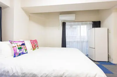 a bedroom with a white bed and a refrigerator at ksi\u5357\u5e38\u76e4\u53f0302 in Tokyo
