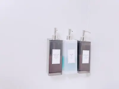 a group of three perfume bottles on a shelf at ksi\u5357\u5e38\u76e4\u53f0302 in Tokyo