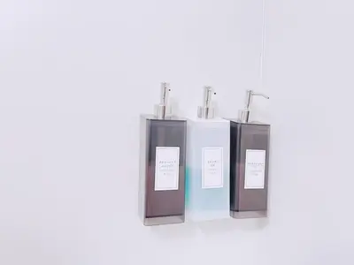 a group of three bottles sitting on a shelf at ksi\u5357\u5e38\u76e4\u53f0402 in Tokyo