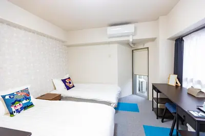 a hotel room with two beds and a desk at ksi\u5357\u5e38\u76e4\u53f0501 in Tokyo