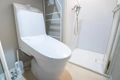 a white toilet in a bathroom with a shower at 425Room,Newly renovated 20 square meters in Shibuya 6 minutes walk to Shibuya with direct access to multiple lines in Tokyo