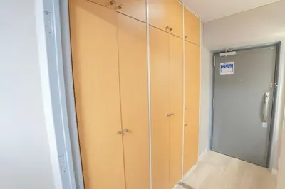 a closet with wooden cabinets and a mirror at 425Room,Newly renovated 20 square meters in Shibuya 6 minutes walk to Shibuya with direct access to multiple lines in Tokyo