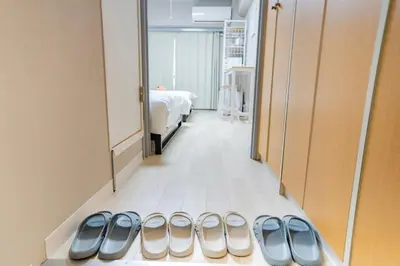 a room with a row of pairs of shoes on the floor at 425Room,Newly renovated 20 square meters in Shibuya 6 minutes walk to Shibuya with direct access to multiple lines in Tokyo