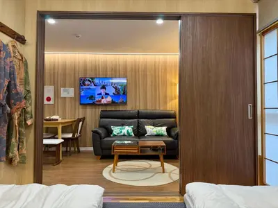 a living room with a couch and a table at TOKYO SKYTREE HOUSE-Multiple room styles in Tokyo
