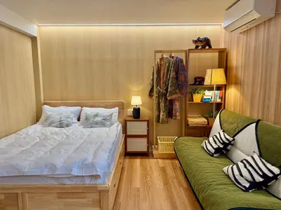 a bedroom with a bed and a green couch at TOKYO SKYTREE HOUSE-Multiple room styles in Tokyo