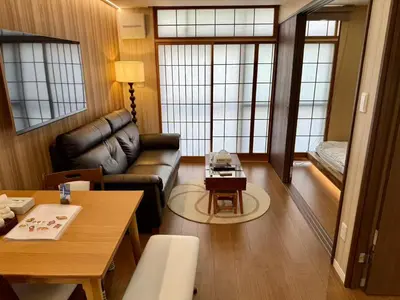 a living room with a couch and a table at TOKYO SKYTREE HOUSE-Multiple room styles in Tokyo