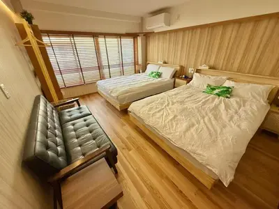 a room with two beds and a couch in it at TOKYO SKYTREE VILLIA-Whole villia space perfect for families and groups in Tokyo