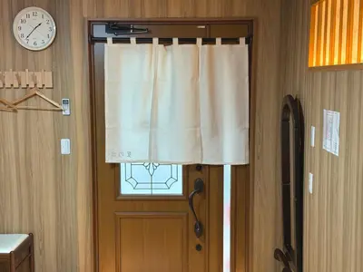 a door with a window with a curtain and a clock at TOKYO SKYTREE VILLIA-Whole villia space perfect for families and groups in Tokyo