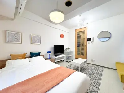 a bedroom with a white bed and a television at Stylish ROCO house Omori8min in Tokyo