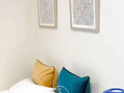 two pillows on a couch with two pictures on the wall at Stylish ROCO house Omori8min in Tokyo