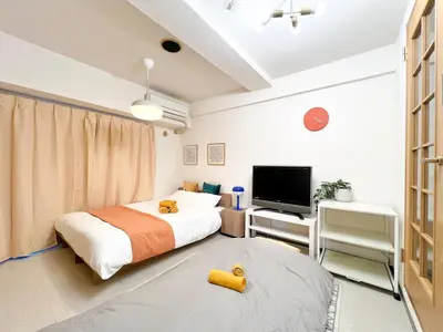a bedroom with a bed and a flat screen tv at Stylish ROCO house Omori8min in Tokyo