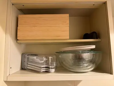 a cupboard with bowls and other kitchen items on it at Stylish ROCO house Omori8min in Tokyo
