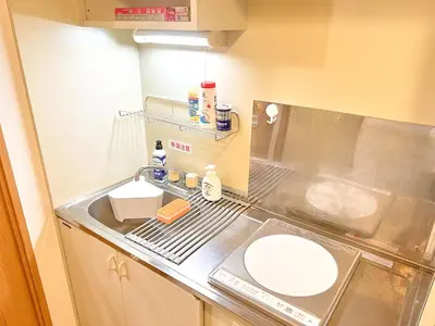 a small kitchen with a sink and a counter top at Stylish ROCO house Omori8min in Tokyo