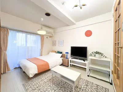 a bedroom with a bed and a flat screen tv at Stylish ROCO house Omori8min in Tokyo