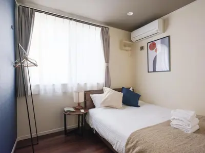 a hotel room with a bed and a window at \u30bc\u30a6\u30b9\u6c60\u4e0a Zeus Ikegami in Tokyo