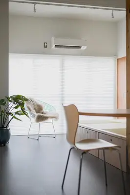 a room with two chairs and a desk and a plant at Cube Sangenjaya in Tokyo