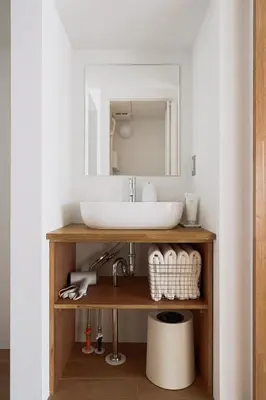 a bathroom with a sink and a mirror at Cube Sangenjaya in Tokyo