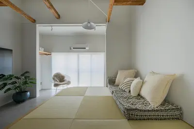 a living room with a couch and a window at Cube Sangenjaya in Tokyo