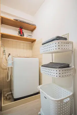a bathroom with a white toilet and a shelf at 2 Minutes Walk to Ikebukuro Station, Modern Stay, Very Convenient in Tokyo