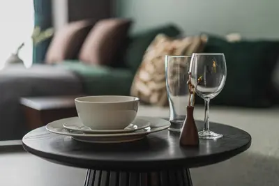 a table with a plate and a cup and a glass at 2 Minutes Walk to Ikebukuro Station, Modern Stay, Very Convenient in Tokyo