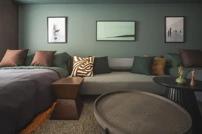 a living room with a couch and a bed at 2 Minutes Walk to Ikebukuro Station, Modern Stay, Very Convenient in Tokyo