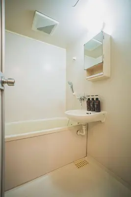 a bathroom with a sink and a bath tub at 2 Minutes Walk to Ikebukuro Station, Modern Stay, Very Convenient in Tokyo