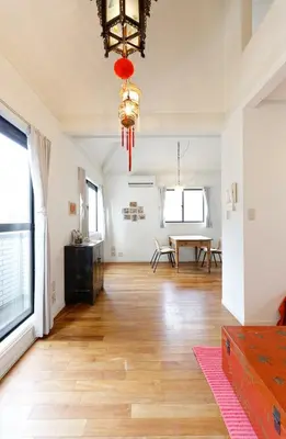 a living room with a wooden floor and a table at Taishido House in Tokyo