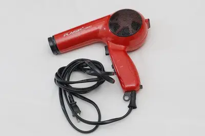 a red blow dryer with a hose attached to it at Taishido House in Tokyo