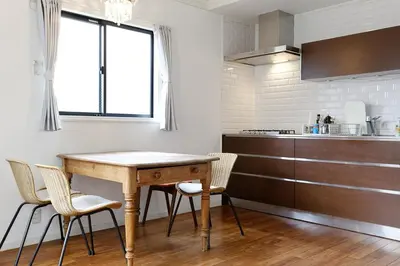 a kitchen with a wooden table and chairs at Taishido House in Tokyo