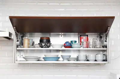 a shelf filled with bowls and dishes in a kitchen at Taishido House in Tokyo