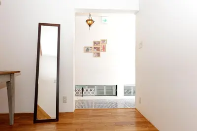 a mirror in a room with a white wall at Taishido House in Tokyo