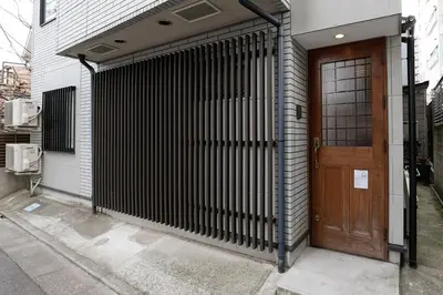 a wooden door in front of a building at Taishido House in Tokyo