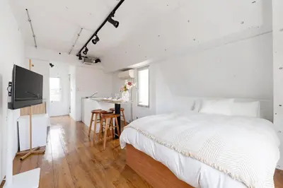 a white bedroom with a bed and a table at Casa di Luce - Stylish Stay near Shibuya & Meguro River Room405 in Tokyo