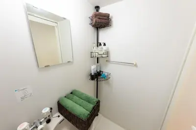 a bathroom with a mirror and a green towel at Villa Boushu KURAMAE in Tokyo