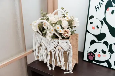 a basket with flowers on a table next to a painting at \u938c\u5009\u56db\u4e01\u76ee in Tokyo
