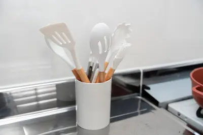 a white cup with utensils in a kitchen at \u938c\u5009\u56db\u4e01\u76ee in Tokyo