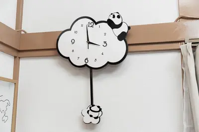 a clock hanging on a wall with panda bears on it at \u938c\u5009\u56db\u4e01\u76ee in Tokyo