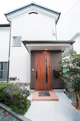a house with a wooden door on the side of it at \u938c\u5009\u56db\u4e01\u76ee in Tokyo