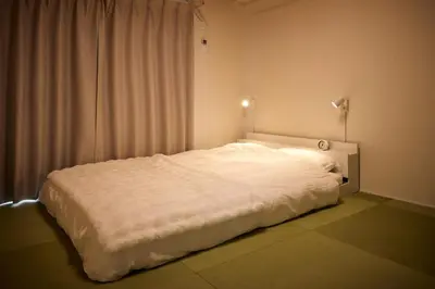 a white bed in a room with a window at Tokyo Retreat -SUMIDA- in Tokyo